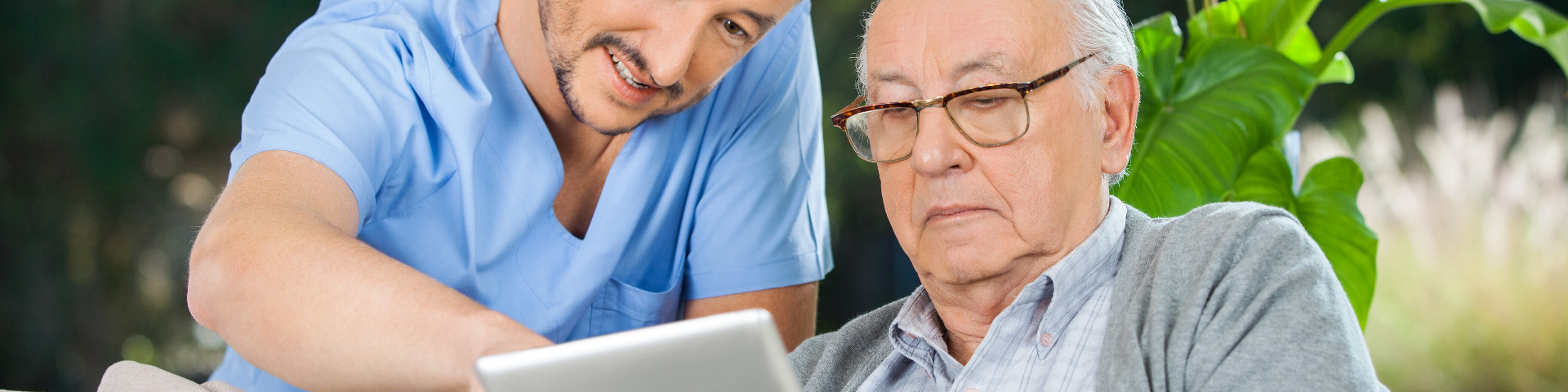 Healthcare worker supporting elderly person with making decisions about their care